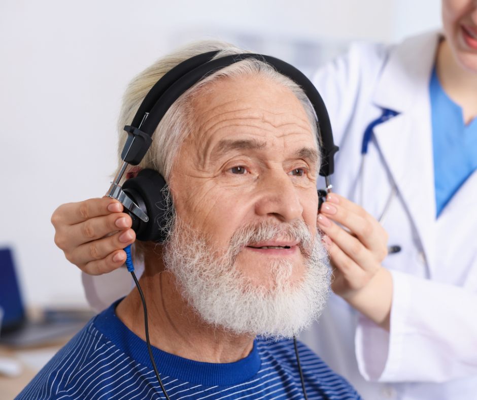 Older man having his hearing evaluated by a healthcare professional